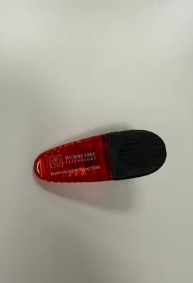 Red binder clip with logo and website We love it