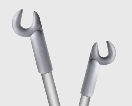 Two metallic wrenches, angled and isolated on a gray background.